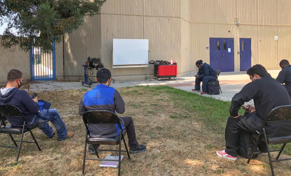 students waiting for outside class "Engines, Fuel and Ignition"  to begin