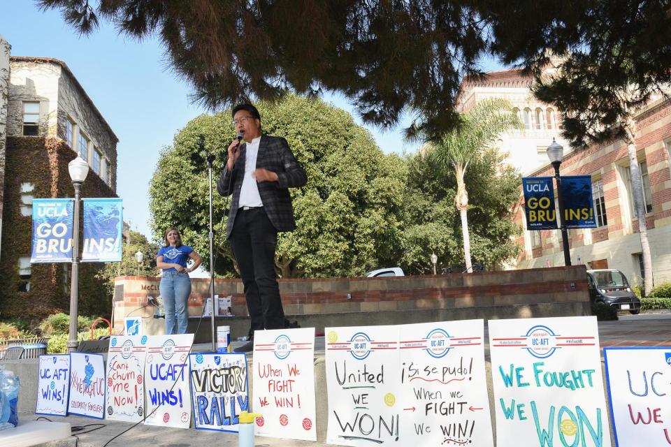 The rally stage framed by victory signs