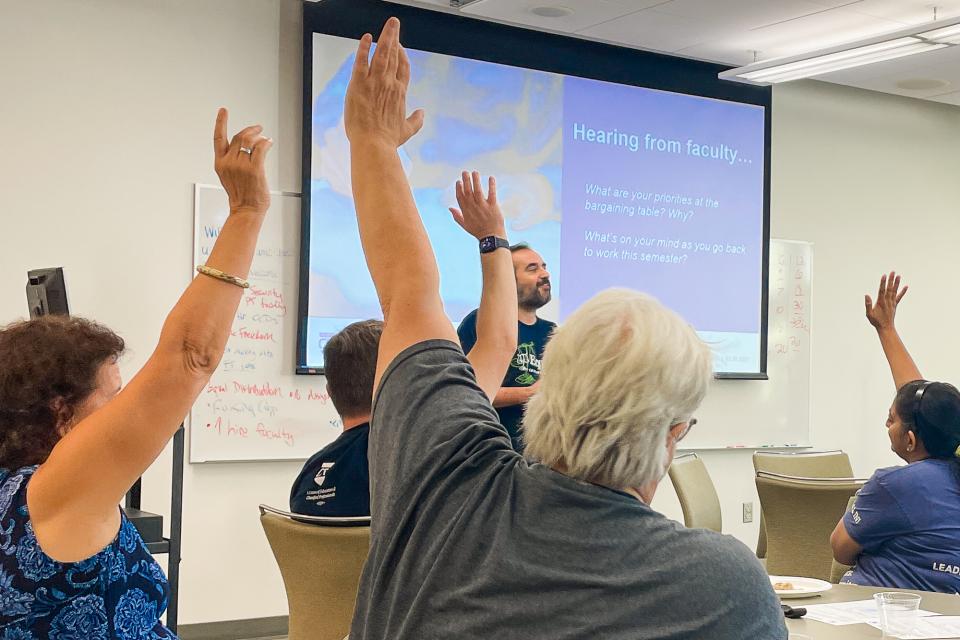 hands raised in support of bargaining for healthcare