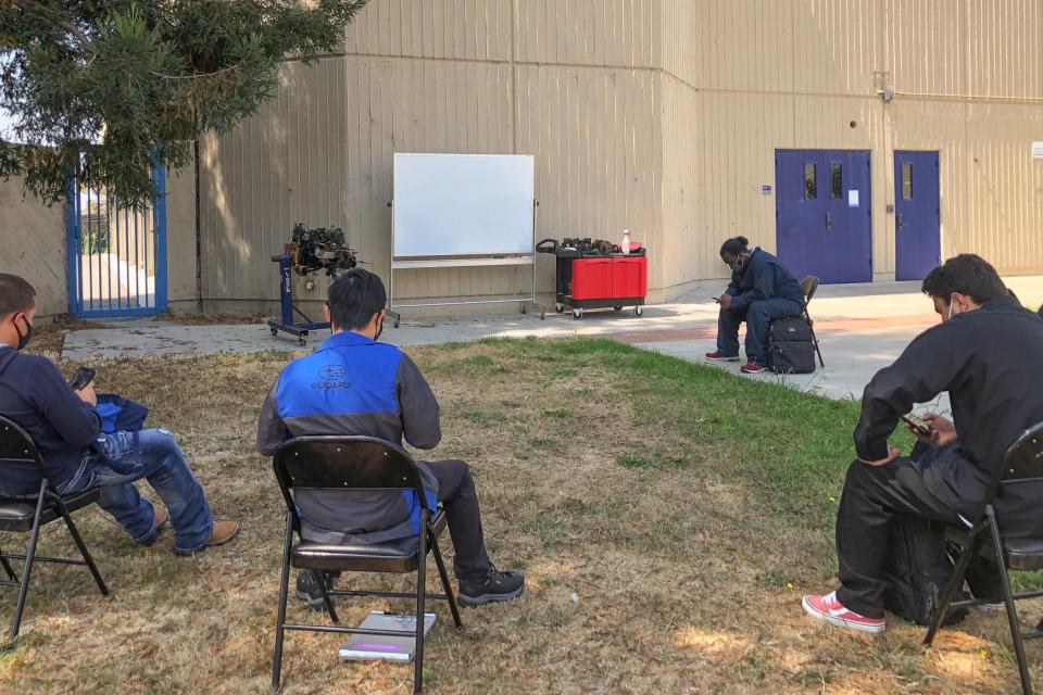 students waiting for outside class "Engines, Fuel and Ignition"  to begin