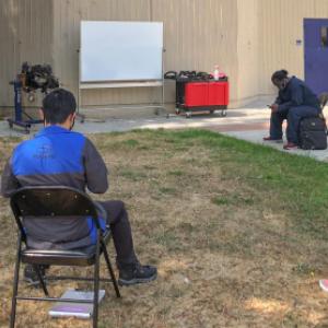 students waiting for outside class "Engines, Fuel and Ignition"  to begin